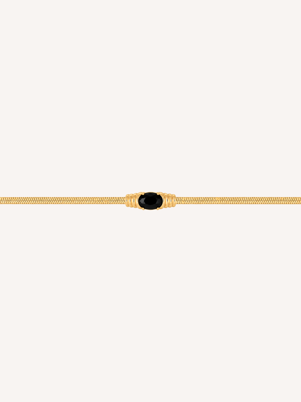 Gold snake chain bracelet with an oval black onyx stone centerpiece.