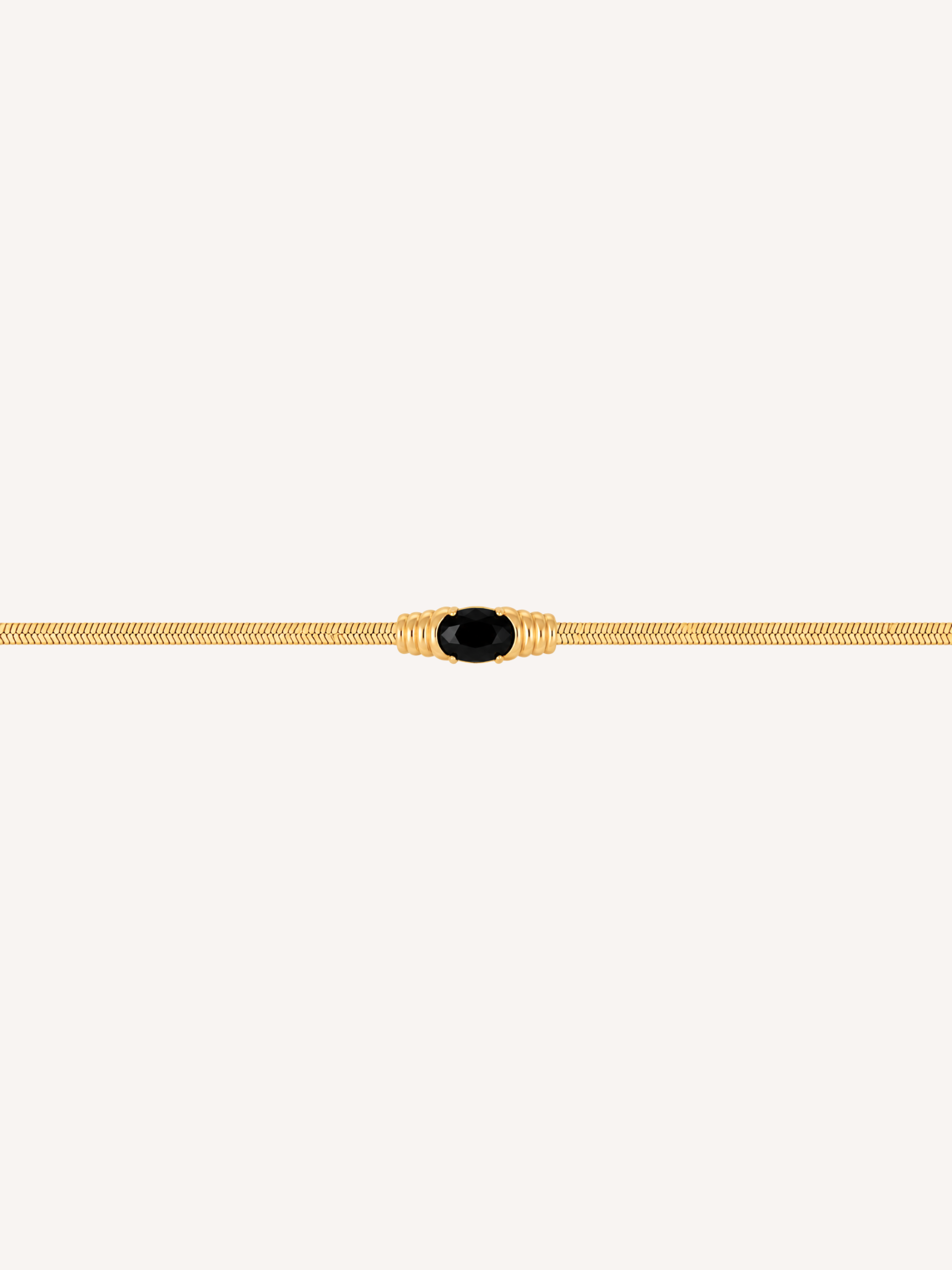 Gold snake chain bracelet with an oval black onyx stone centerpiece.