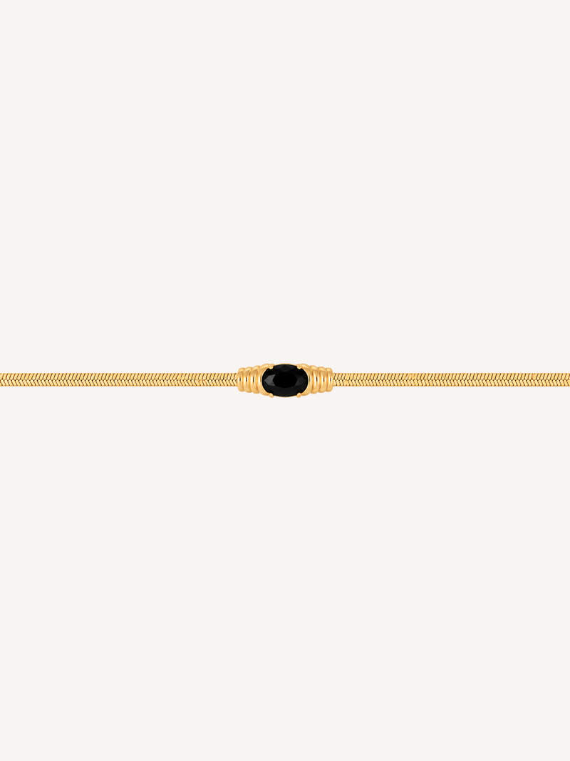 Gold snake chain bracelet with an oval black onyx stone centerpiece.