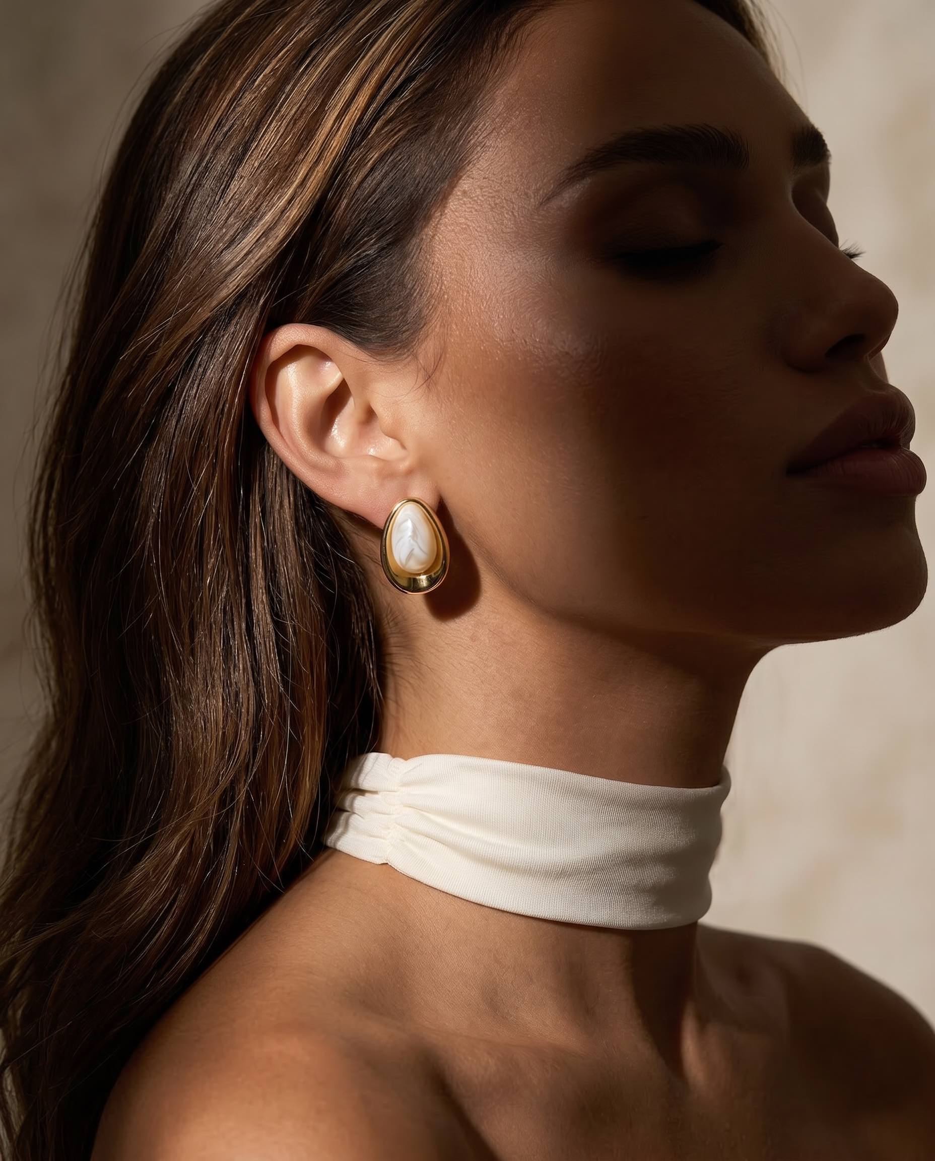 aspen gold marble teardrop statement earrings worn on model bold sculptural