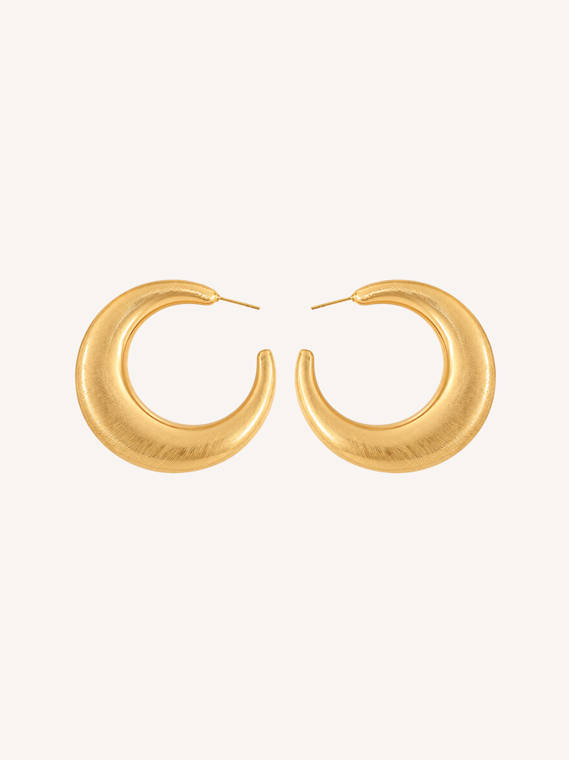 Chunky brushed gold hoop earrings featuring a textured finish and rounded silhouette.