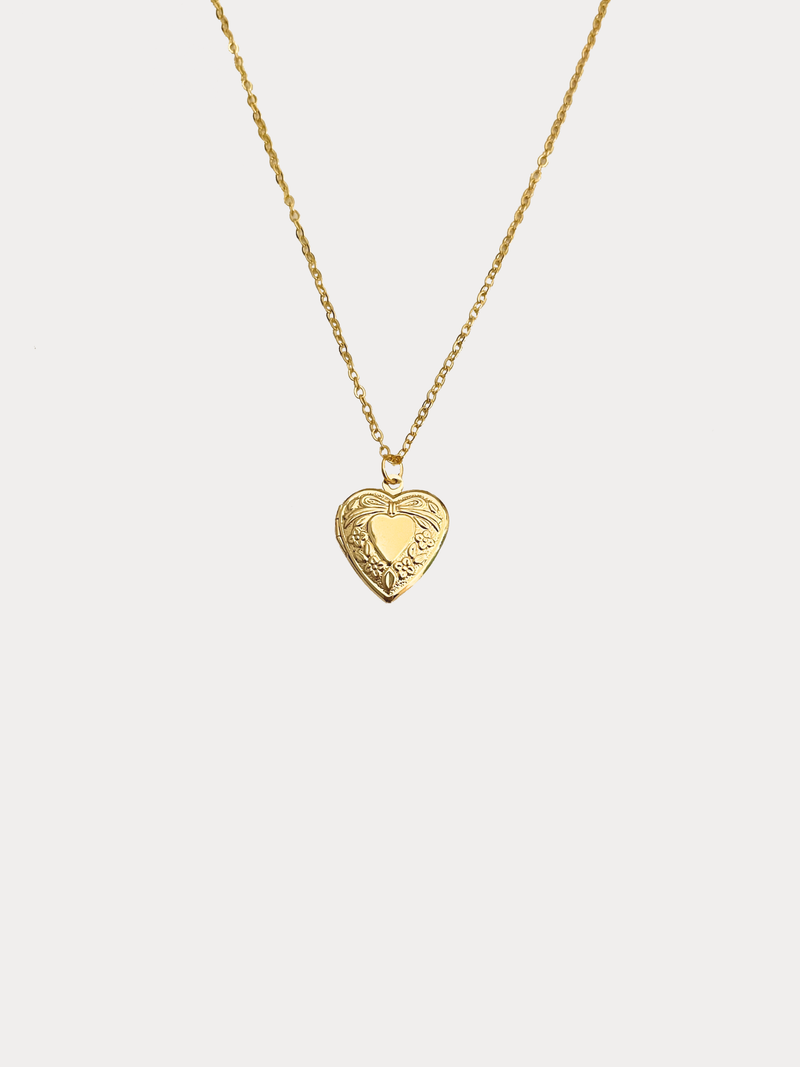 Gold classic heart locket necklace with a bow and subtle floral detailing