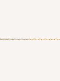 Gold bracelet featuring cubic zirconia stones paired with elongated paperclip links.