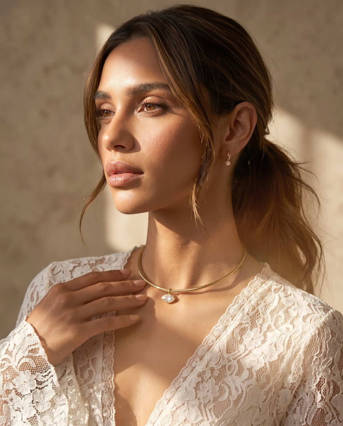 gold pearl huggie drop earrings worn on model elegant everyday jewelry