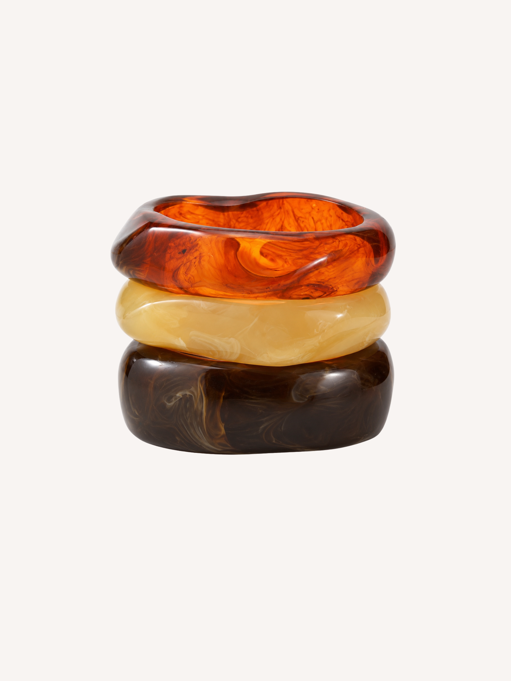 Set of three chunky resin bangles in amber tortoise, ivory, and espresso marbled finishes.