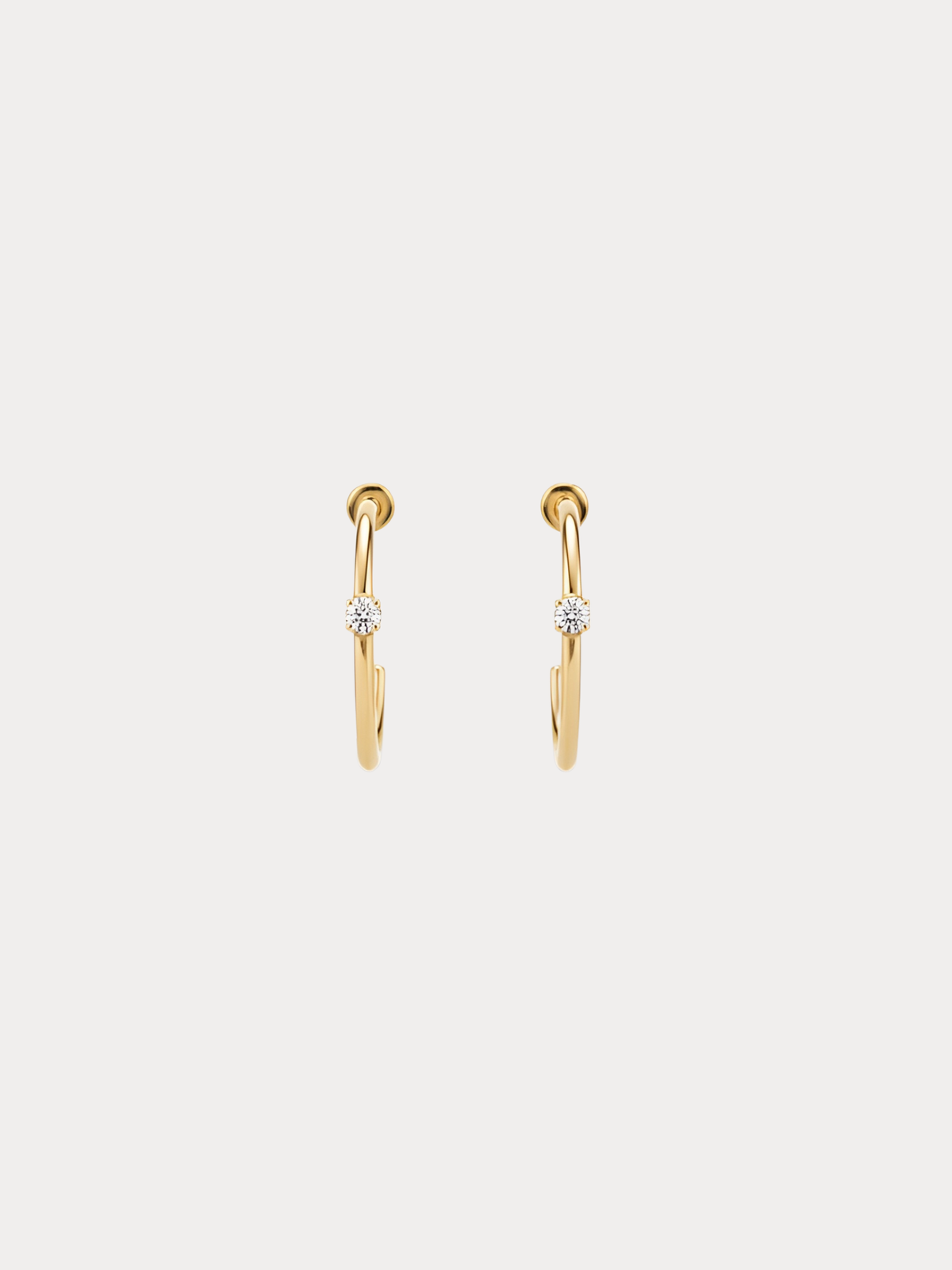 Gold hoop earrings with small crystal accent