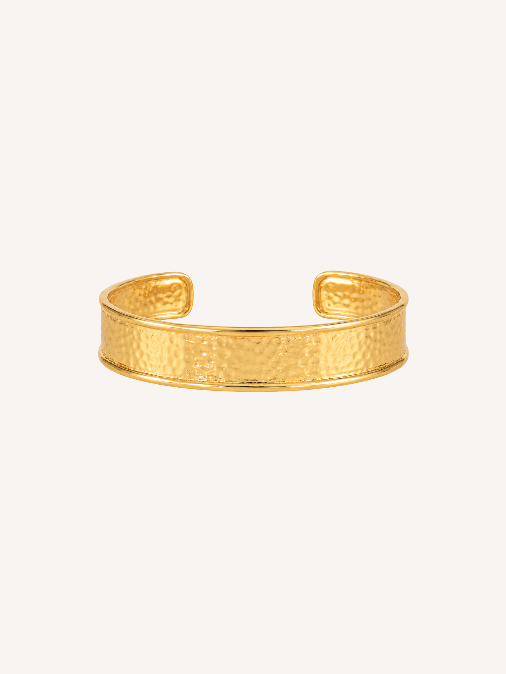 Hammered gold cuff bracelet with a wide textured open cuff design.
