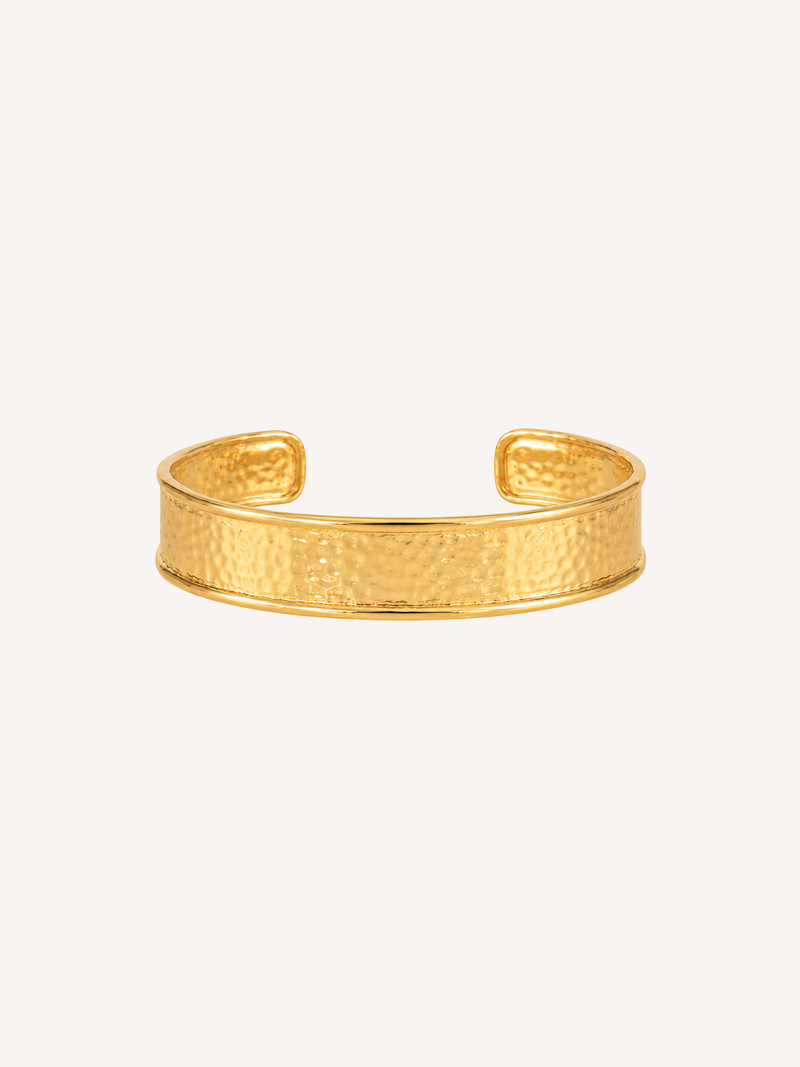 Hammered gold cuff bracelet with a wide textured open cuff design.