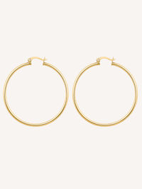 18k large gold hoop earrings with a thin tube silhouette and polished tarnish free waterproof finish.