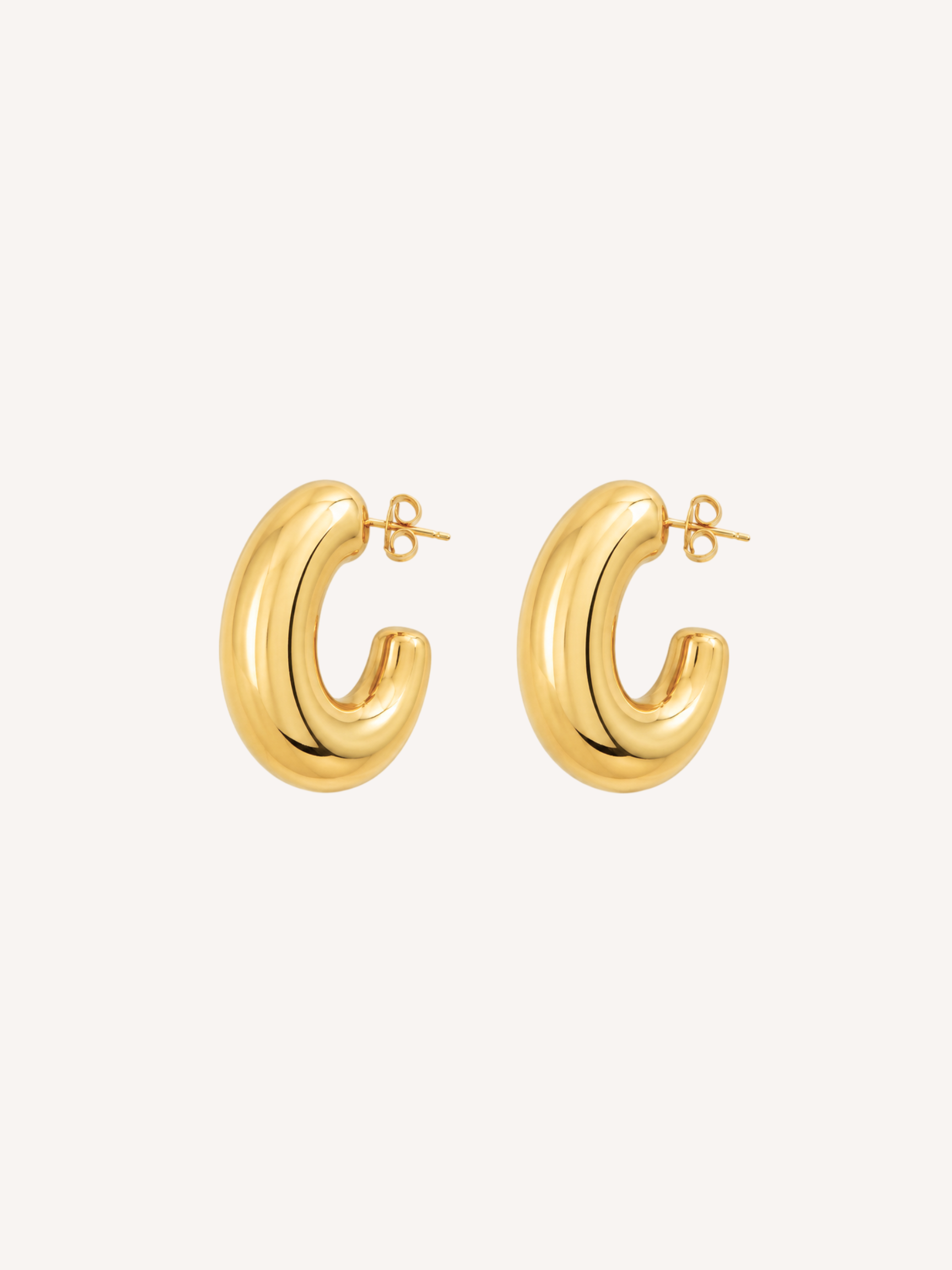 Chunky gold hoop earrings featuring a thick tubular silhouette and polished finish.
