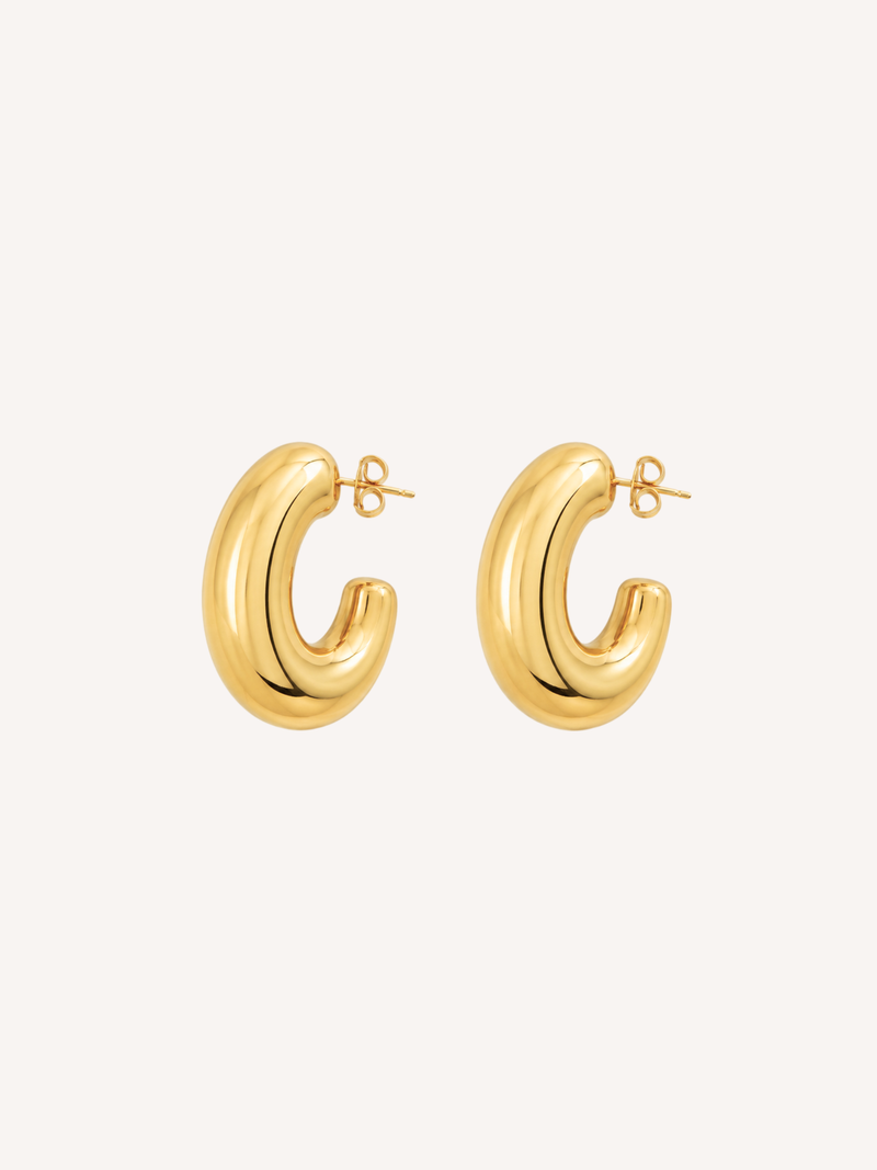 Chunky gold hoop earrings featuring a thick tubular silhouette and polished finish.