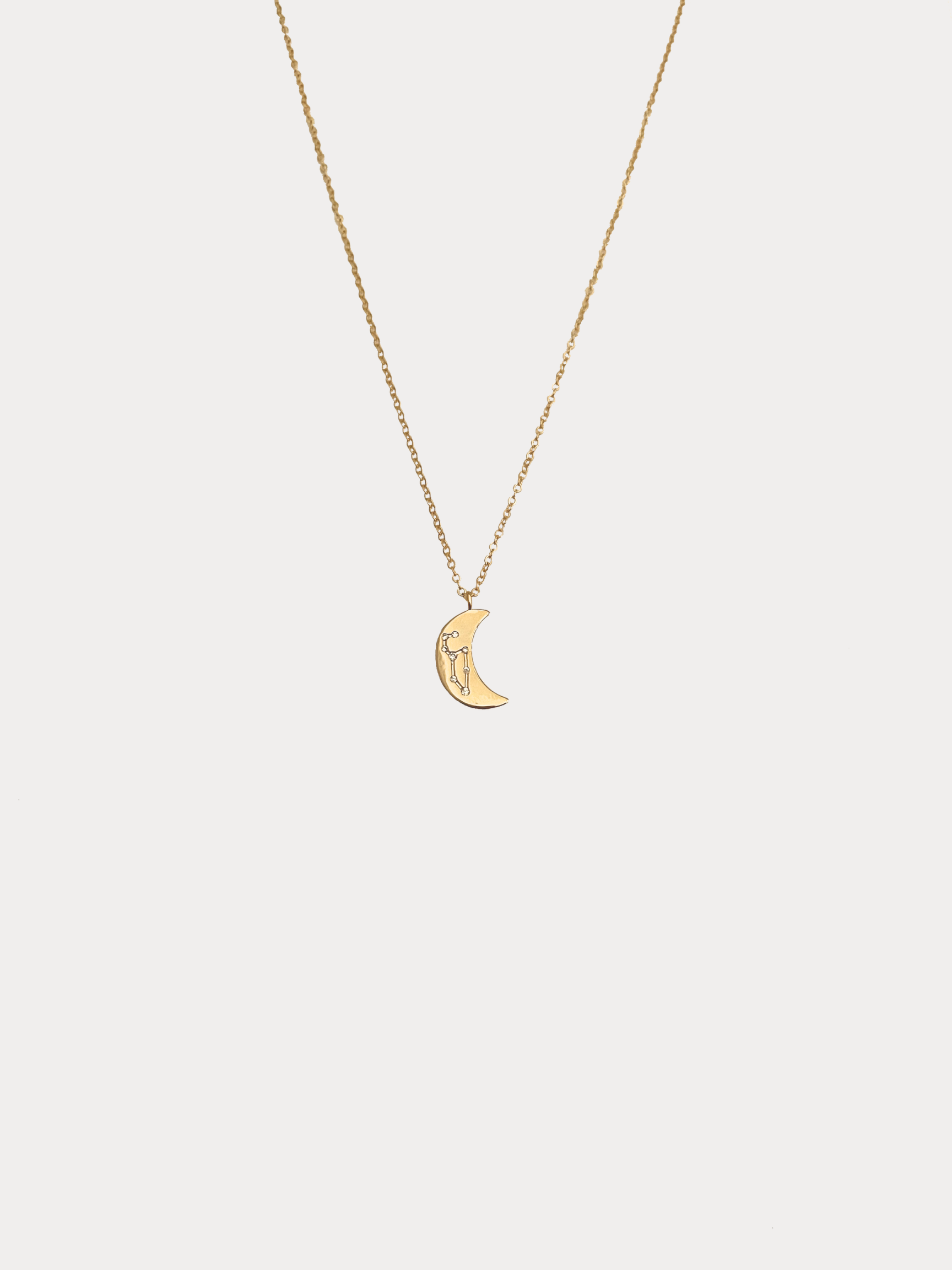 Gold Leo crescent moon necklace with constellation detailing