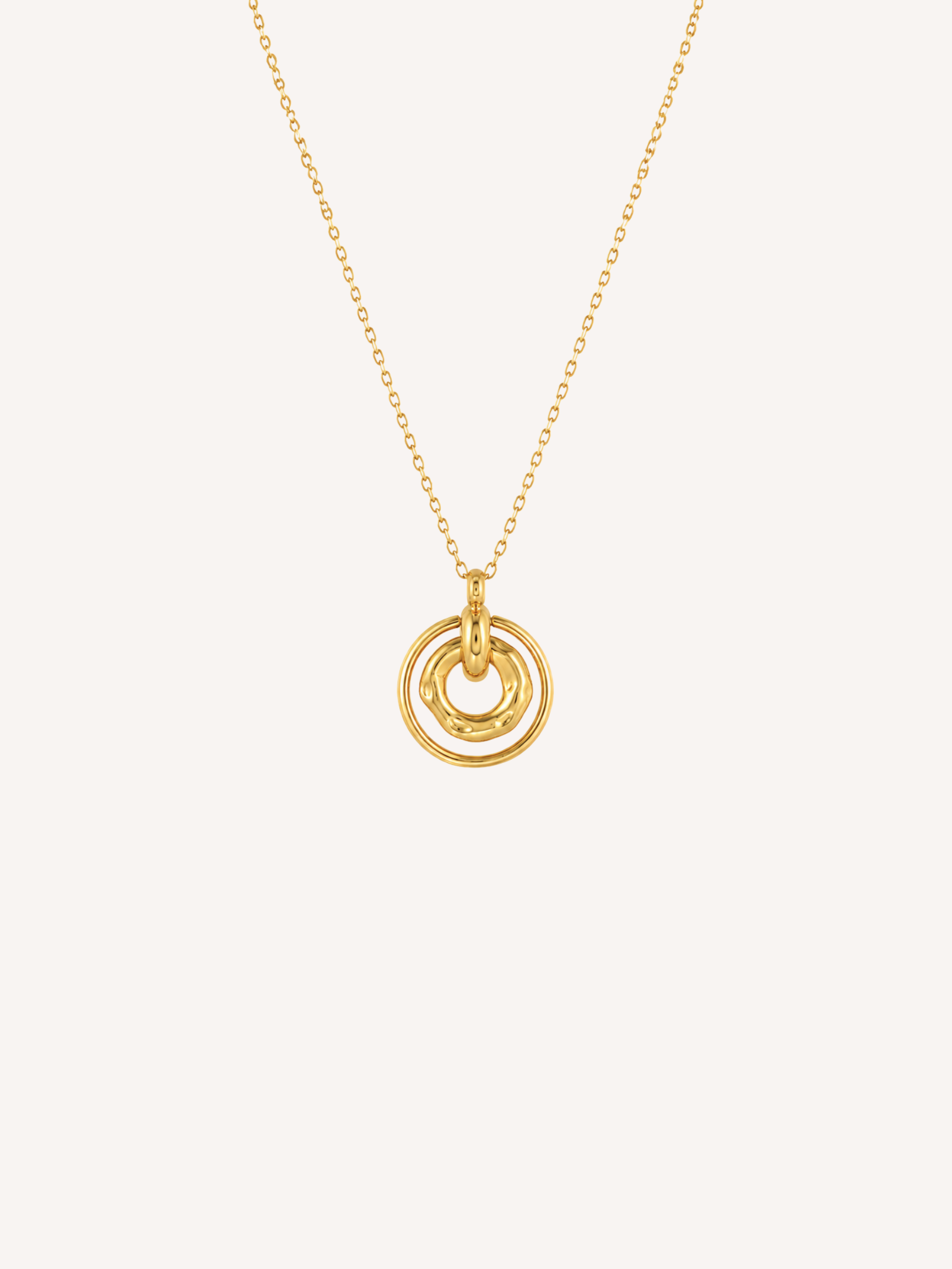 Waterproof gold circle necklace with layered rings and an organic molten center pendant.