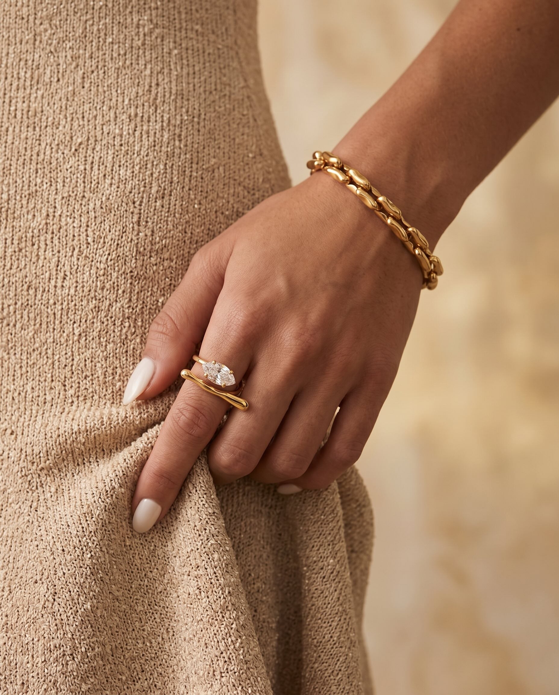 Gold open wrap ring featuring a marquise-cut cubic zirconia stone.