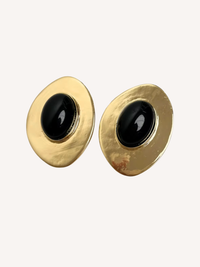 gold sculptural oval earrings with black center stone and organic textured finish
