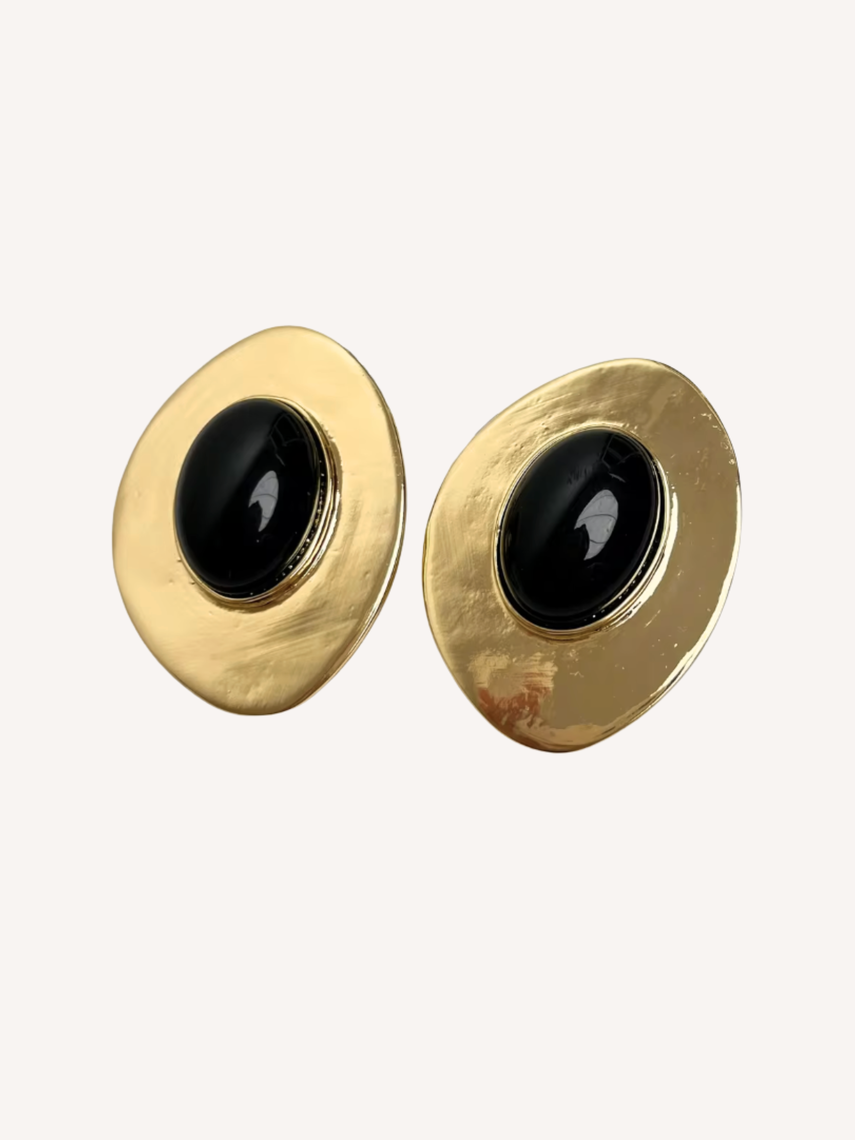 gold sculptural oval earrings with black center stone and organic textured finish