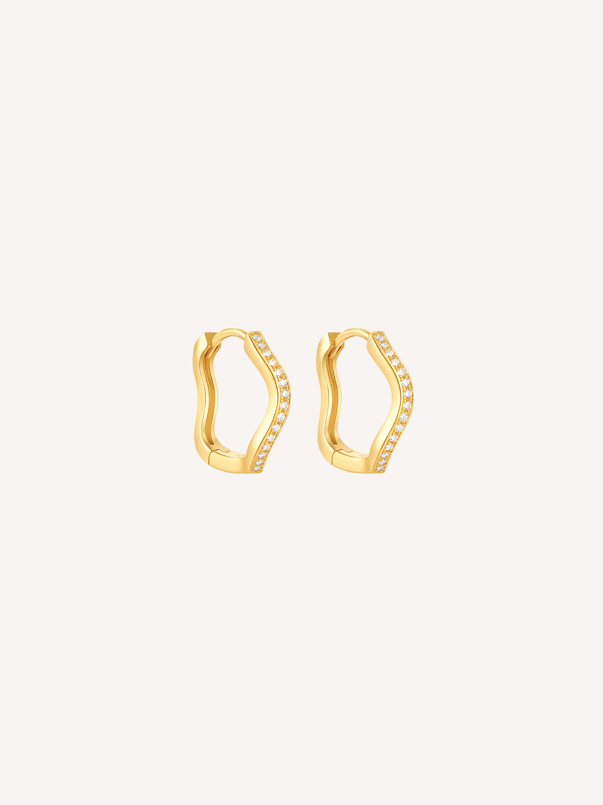 Gold pavé wave huggie earrings featuring cubic zirconia stones and an organic scalloped silhouette.