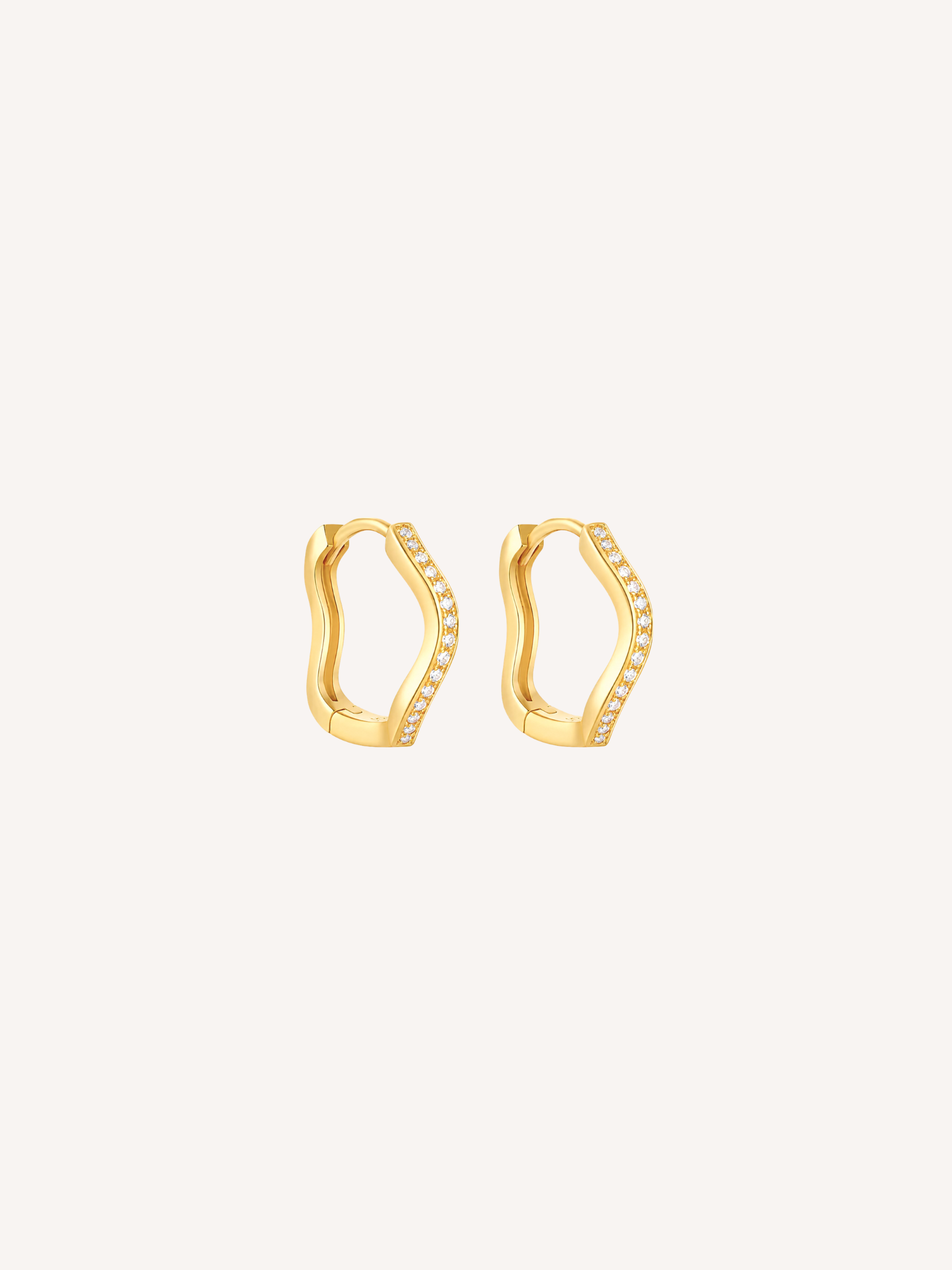 Gold pavé wave huggie earrings featuring cubic zirconia stones and an organic scalloped silhouette.