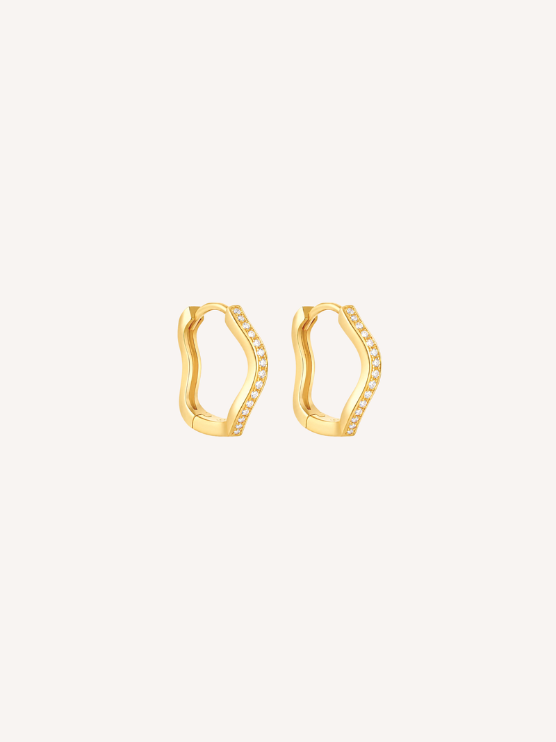 Gold pavé wave huggie earrings featuring cubic zirconia stones and an organic scalloped silhouette.