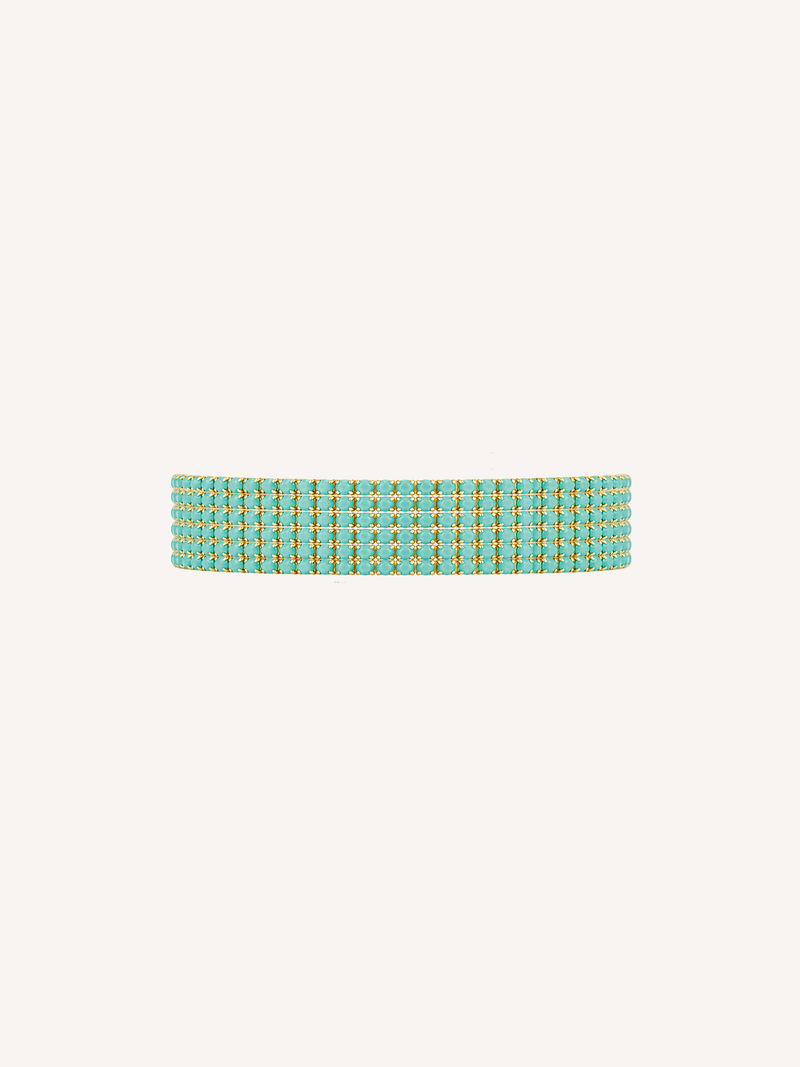 Gold tennis bracelet featuring peacock green cubic zirconia stones.