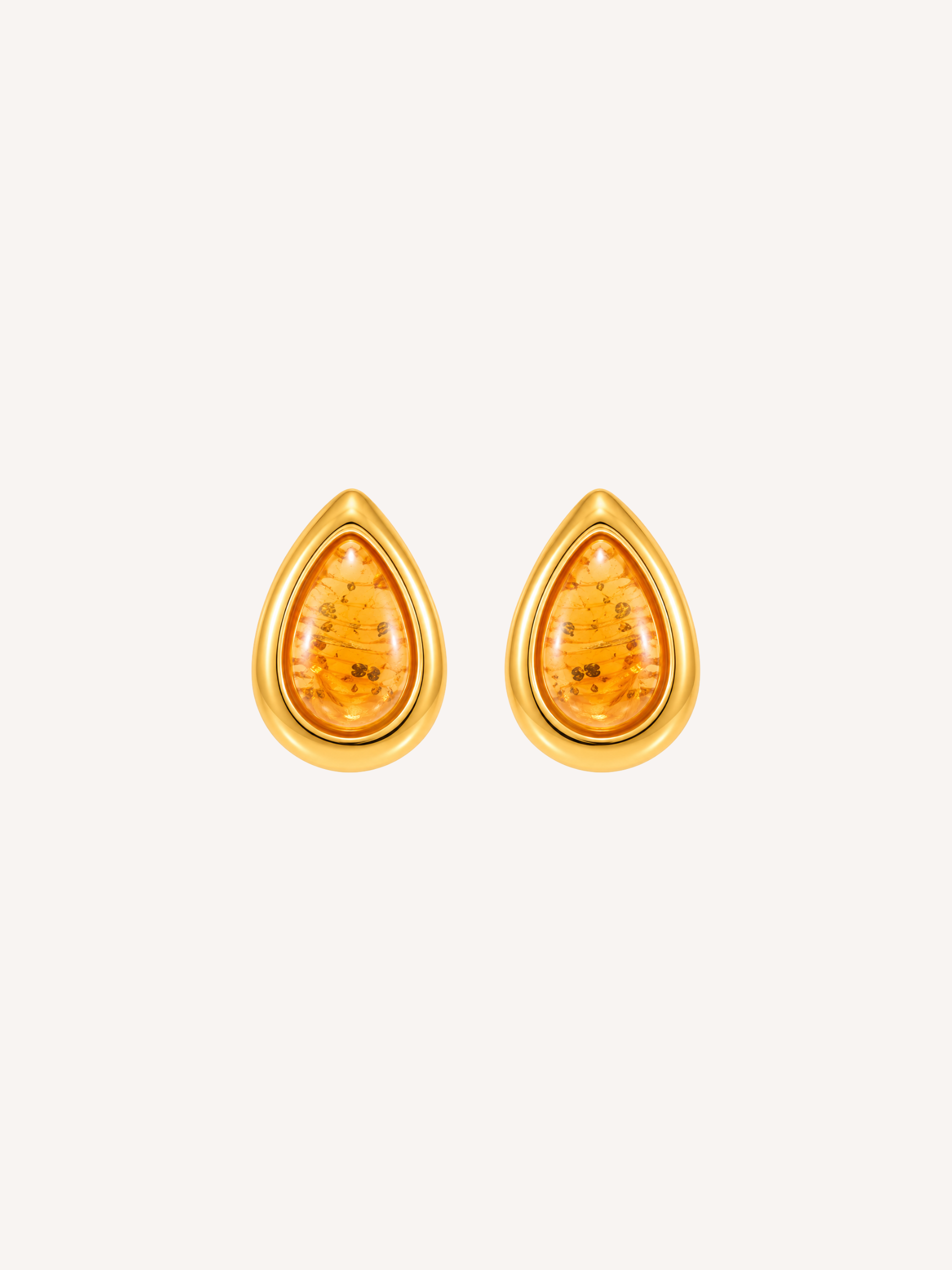 Gold teardrop statement earrings featuring translucent amber resin with gold flecks.
