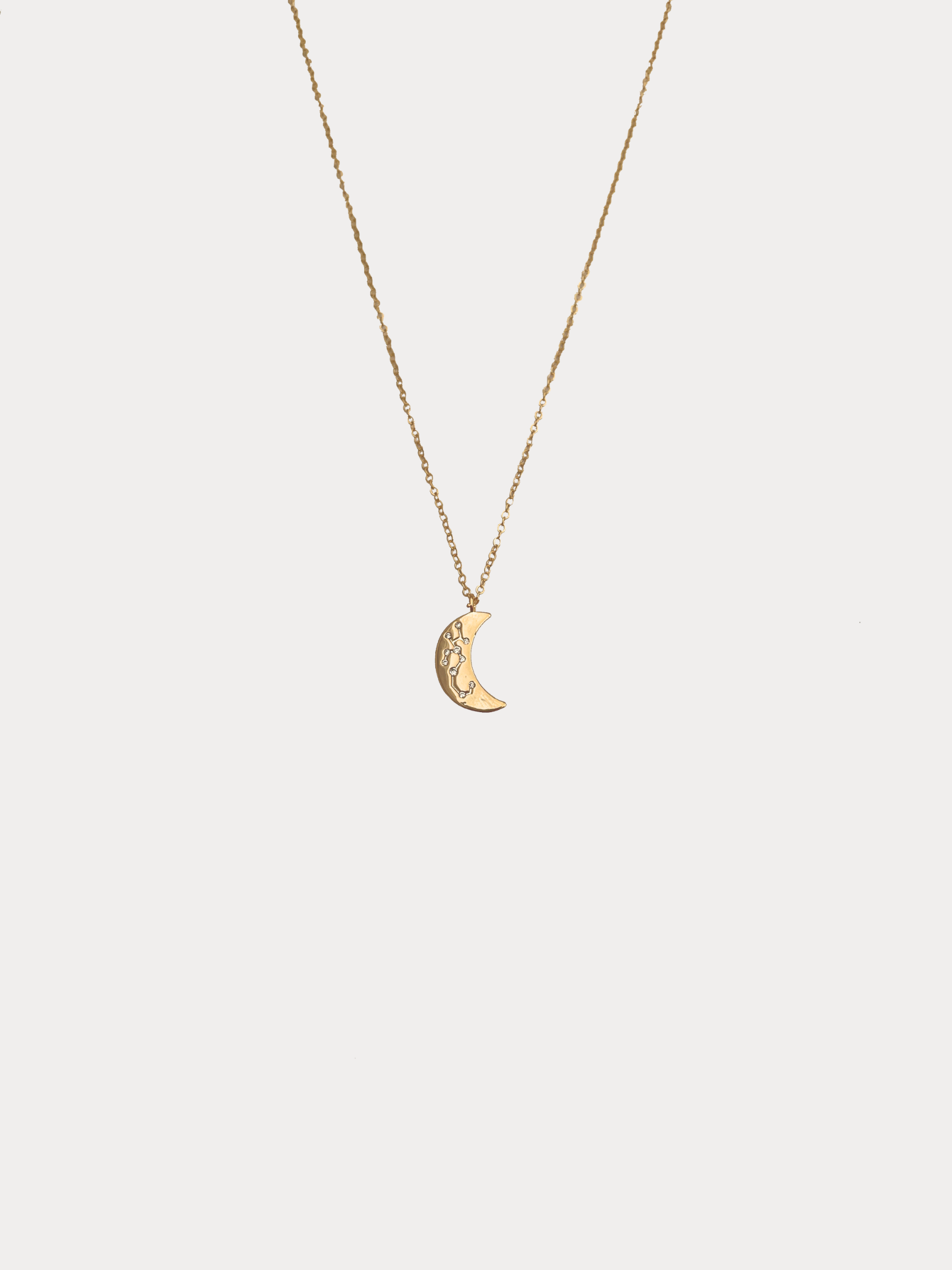 Gold Sagittarius crescent moon necklace with constellation detailing