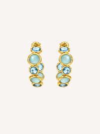 Blue statement gold hoop earrings featuring blue glass and cubic zirconia stones.