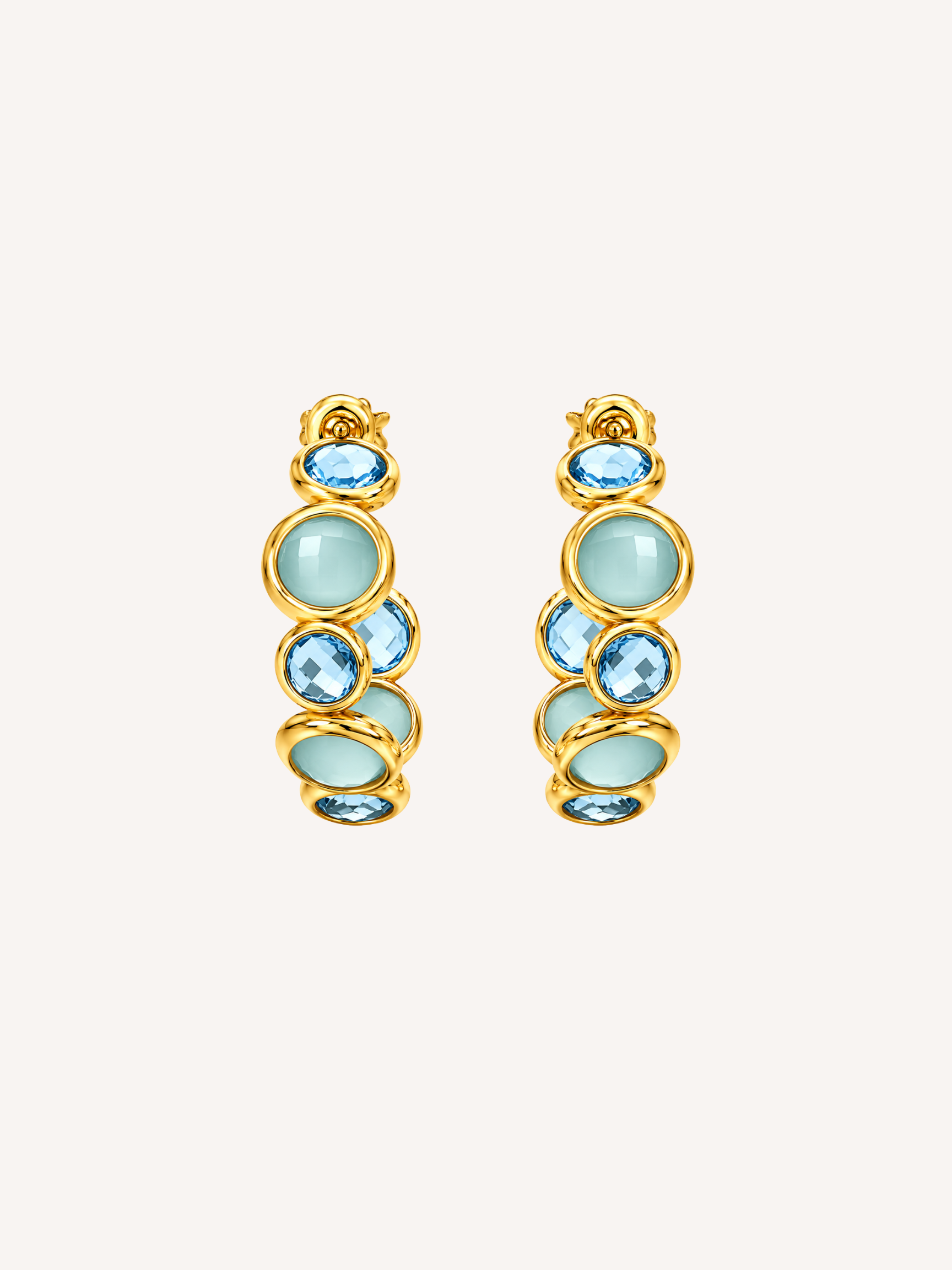 Blue statement gold hoop earrings featuring blue glass and cubic zirconia stones.