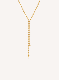 Gold lariat necklace featuring a delicate beaded chain and elongated Y-shaped drop design.