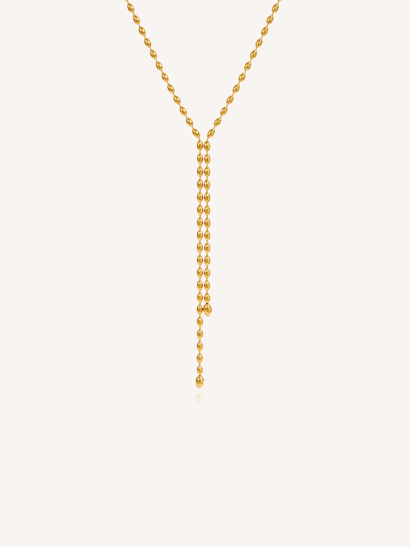 Gold lariat necklace featuring a delicate beaded chain and elongated Y-shaped drop design.