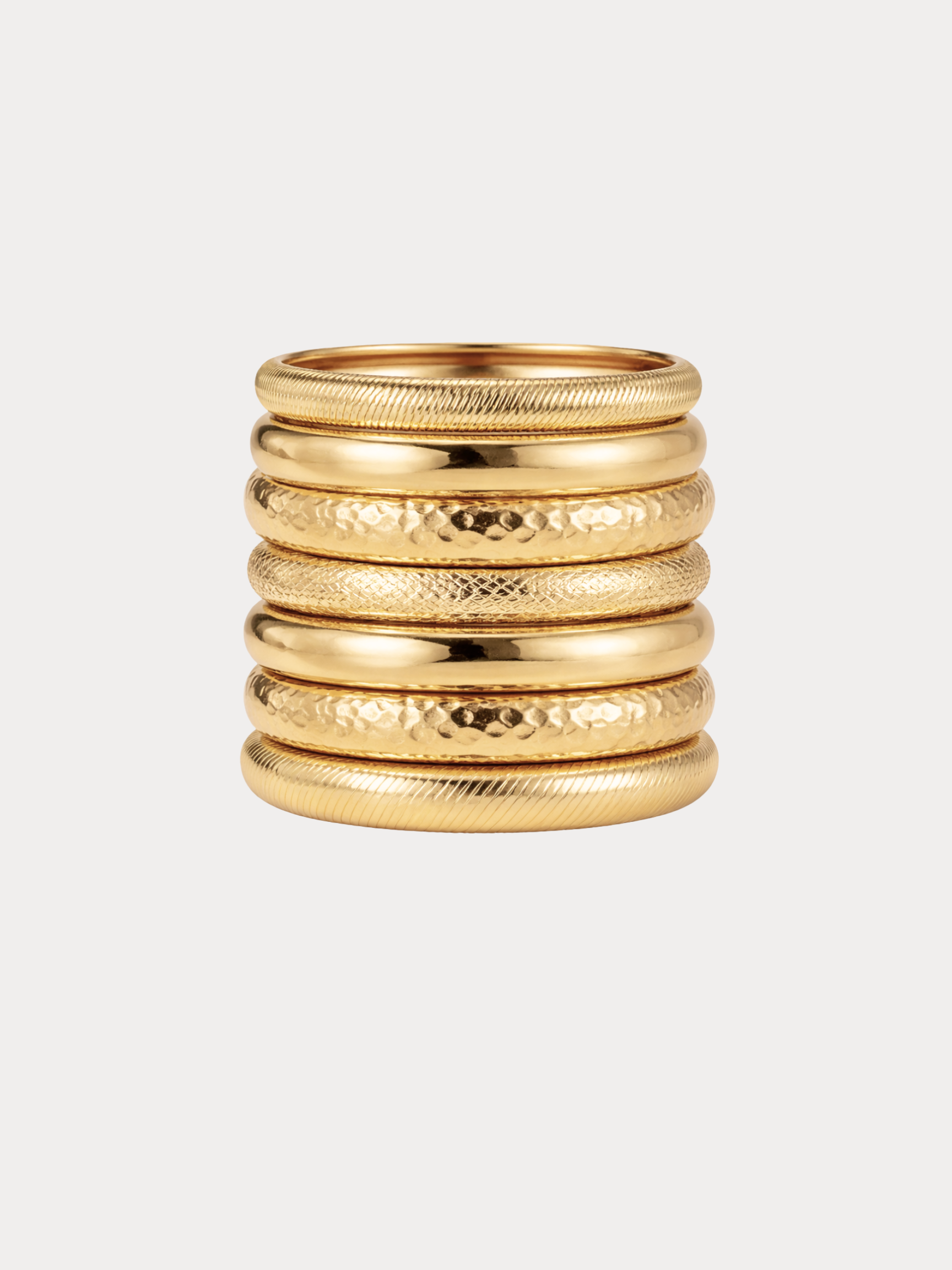 gold stacked bangles with mixed textures and layered festival style