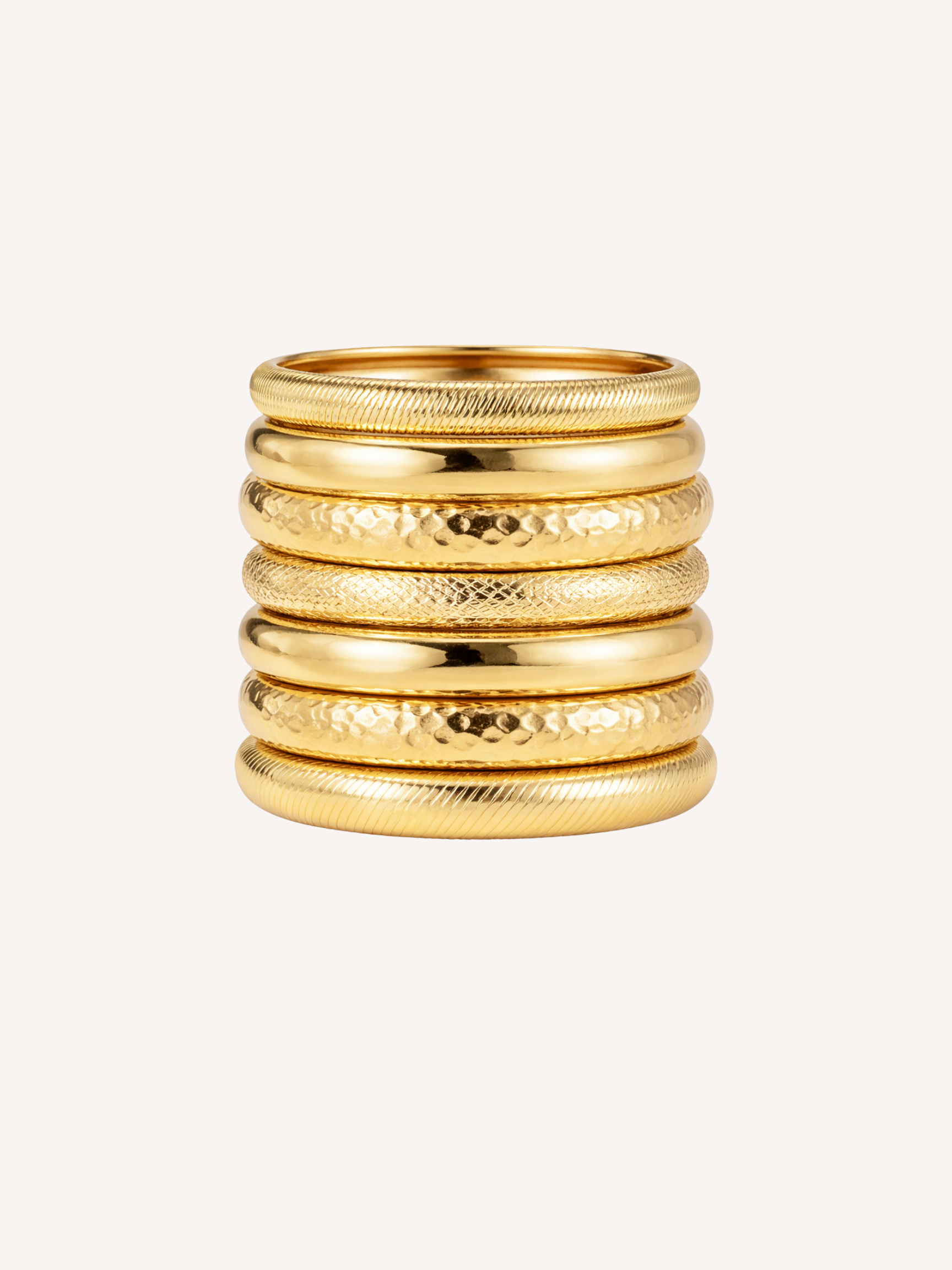 gold stacked bangles with mixed textures and layered festival style