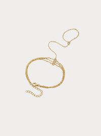 gold handchain bracelet with delicate chains and crystal accents