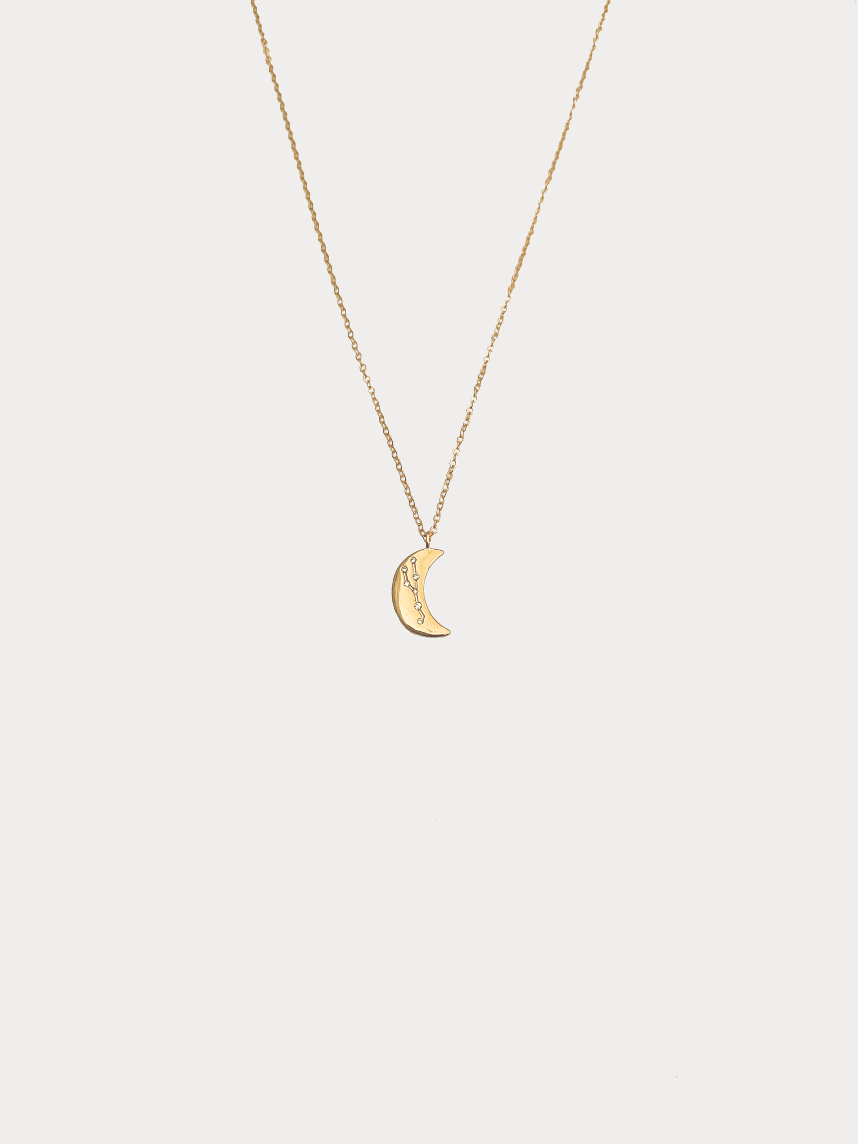 Gold Taurus crescent moon necklace with constellation detailing