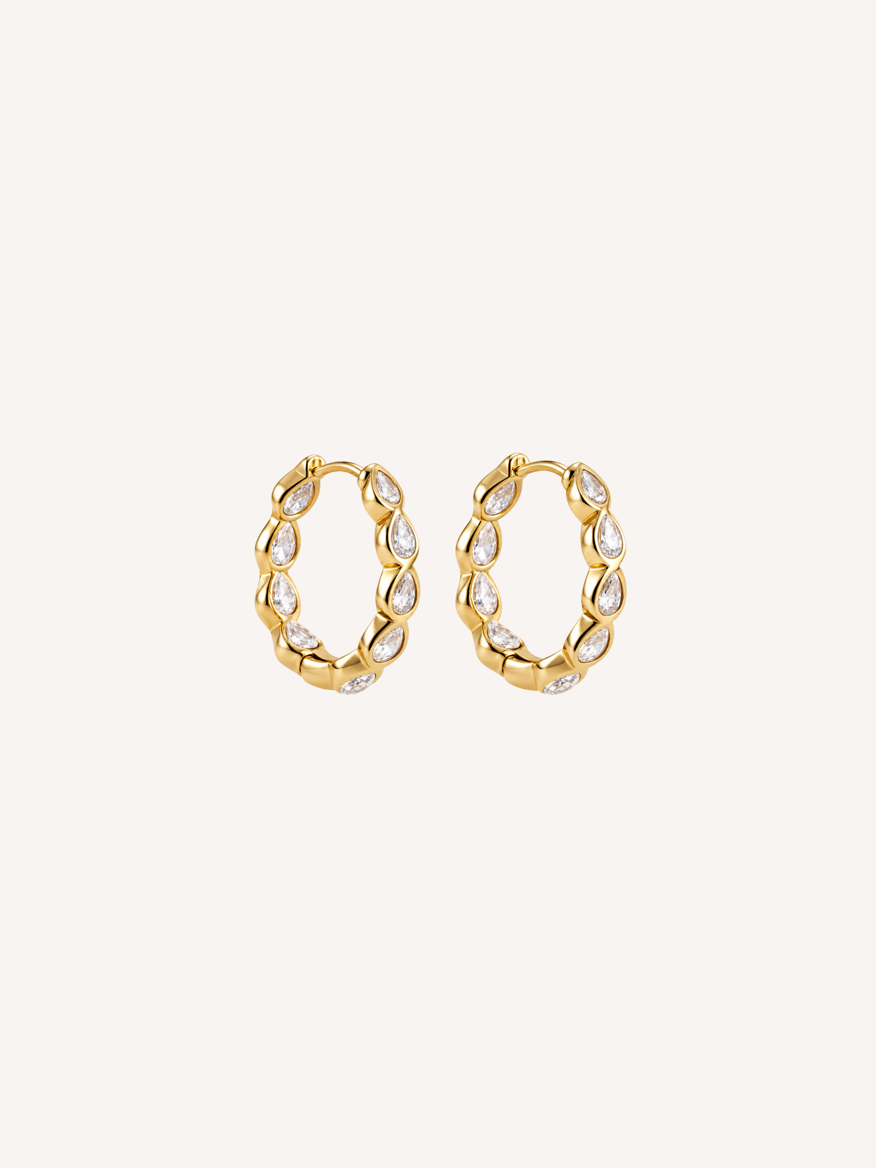 Gold hoop earrings set with pear-shaped cubic zirconia stones.