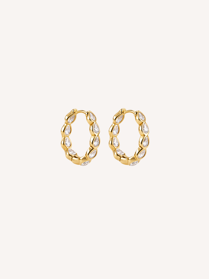 Gold hoop earrings set with pear-shaped cubic zirconia stones.