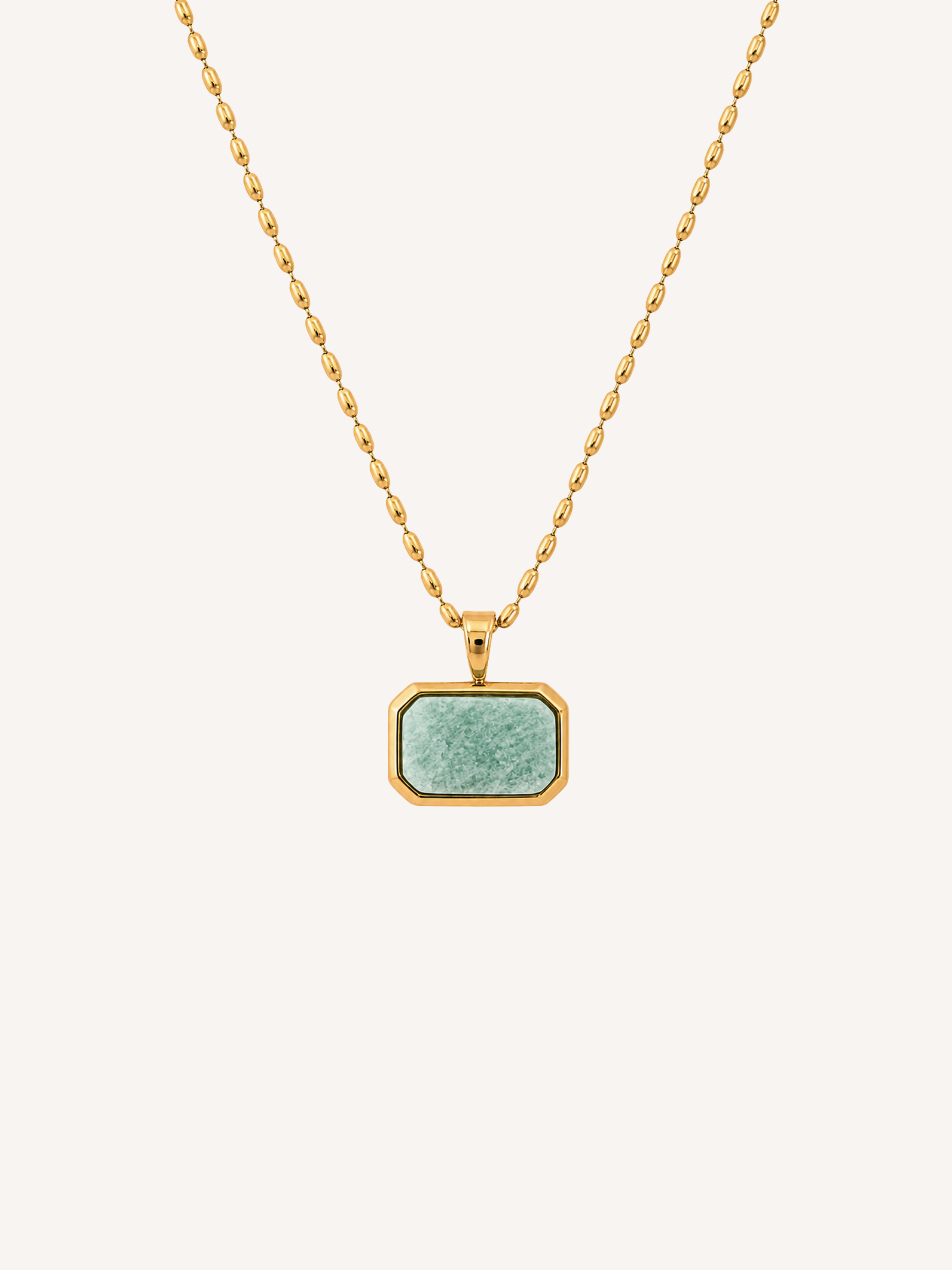 Gold geometric pendant necklace featuring an imitation amazonite stone on a delicate gold chain.