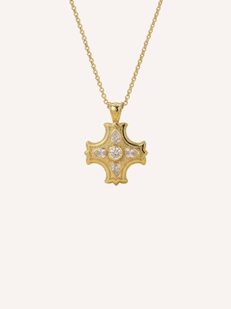 gold cross necklace with center stone and pear shaped accents