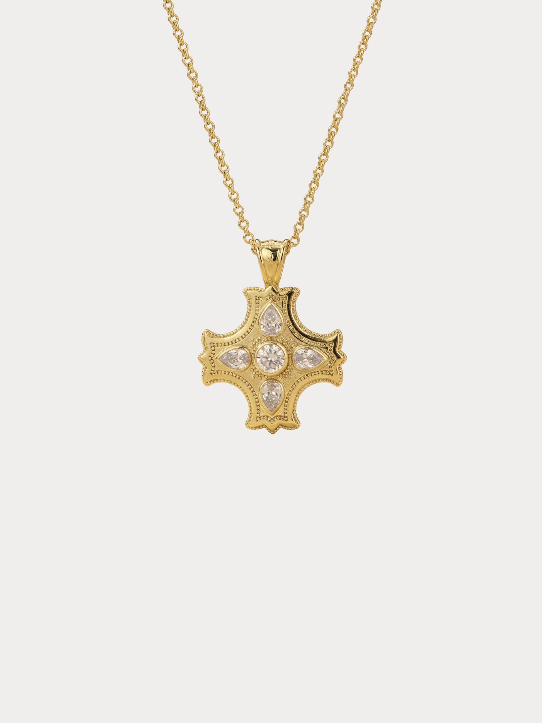 gold cross necklace with center stone and pear shaped accents