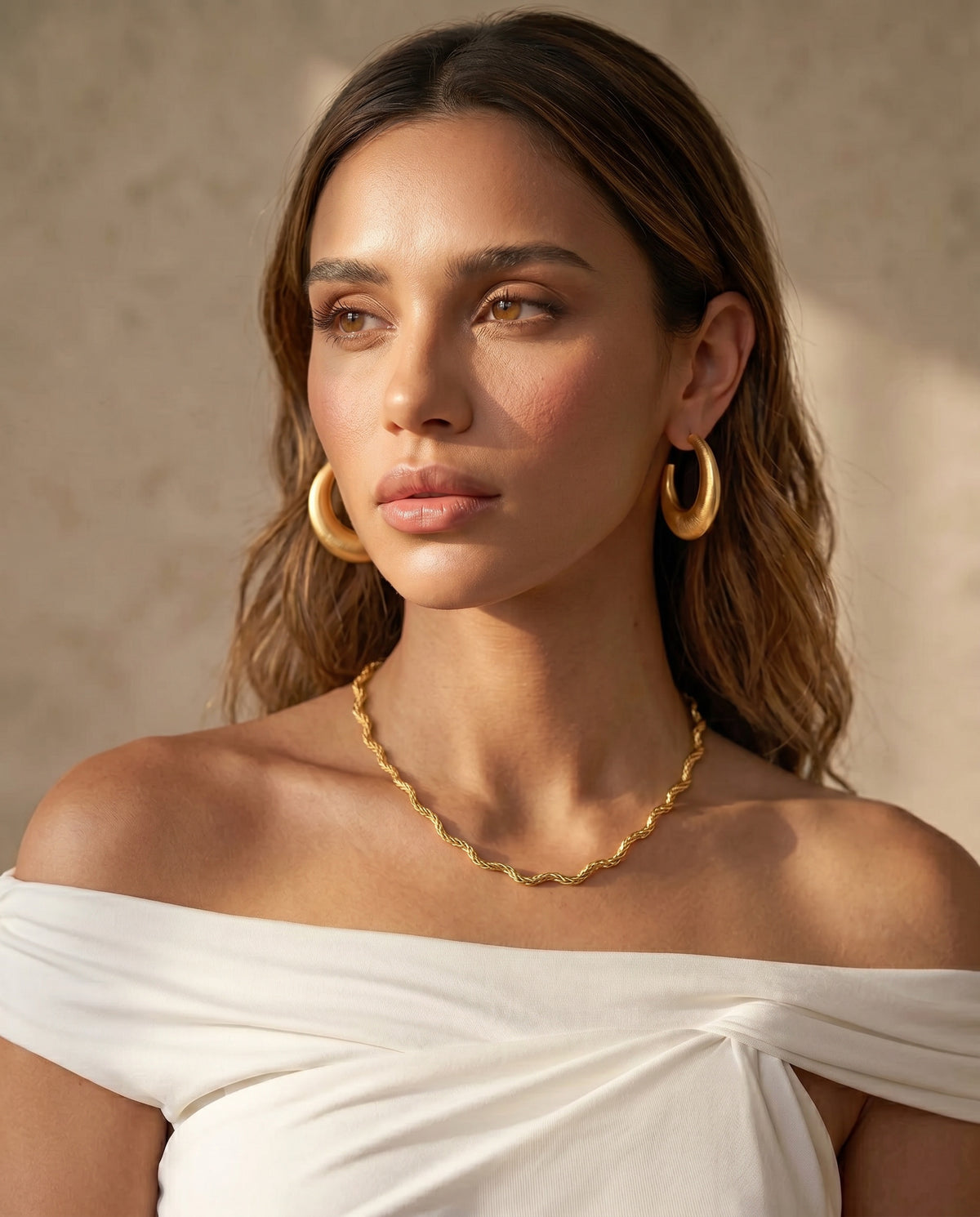 Scalloped gold chain necklace featuring a fluid wave-inspired silhouette and textured finish.